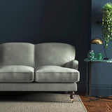 Sofa covered in a grey velvet upholstery fabric