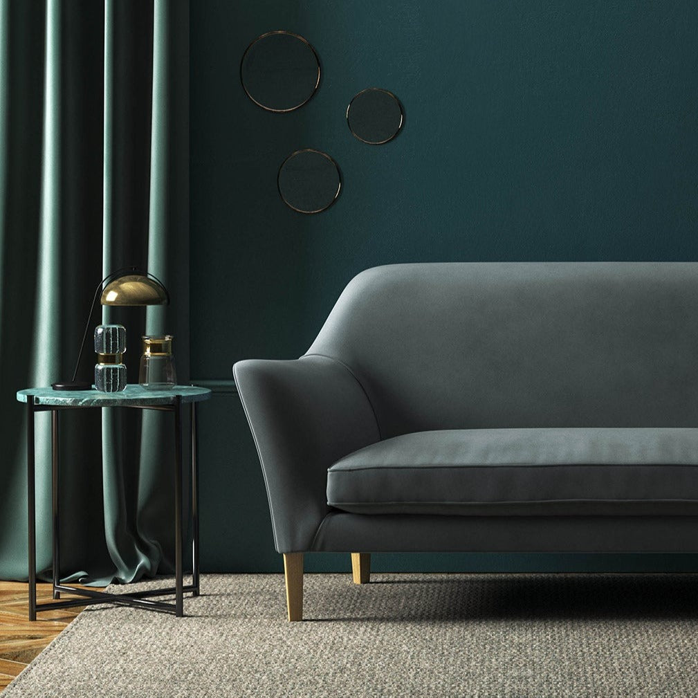 Sofa covered in a grey velvet upholstery fabric 