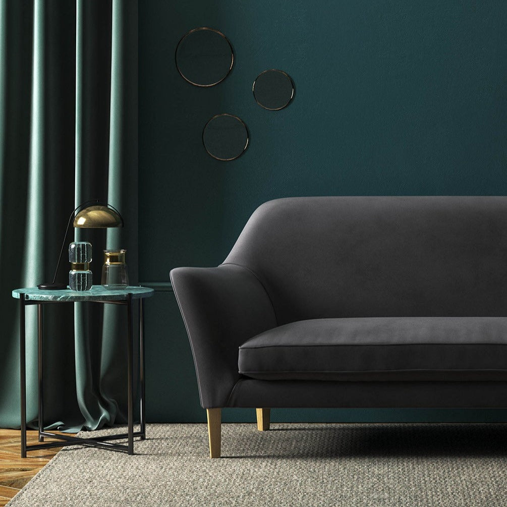 Sofa covered in a purple velvet upholstery fabric 