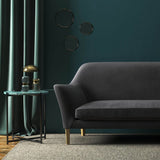 Sofa covered in a purple velvet upholstery fabric 
