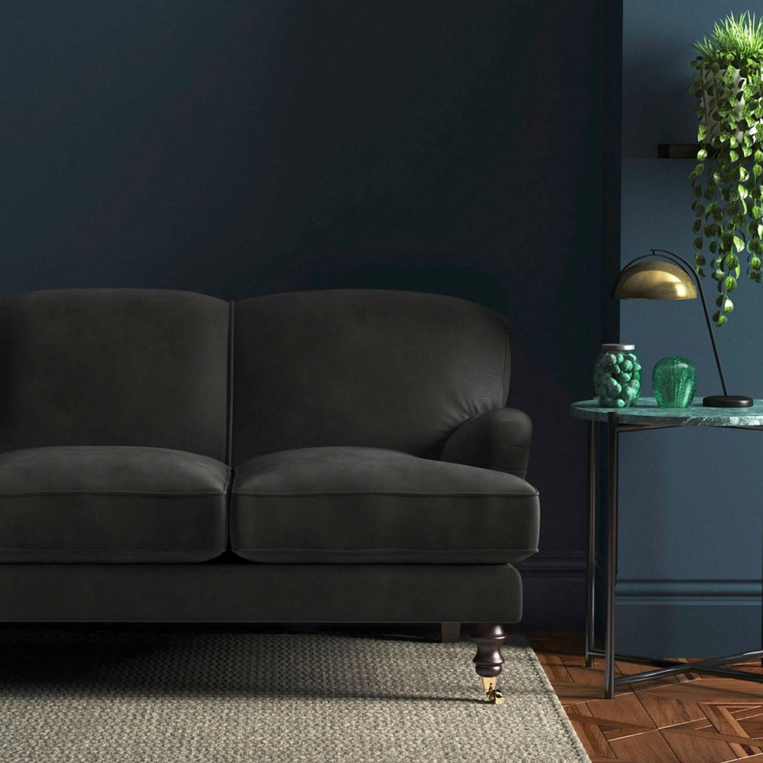 Sofa covered in a grey velvet upholstery fabric