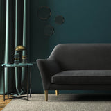 Sofa covered in a grey velvet upholstery fabric 