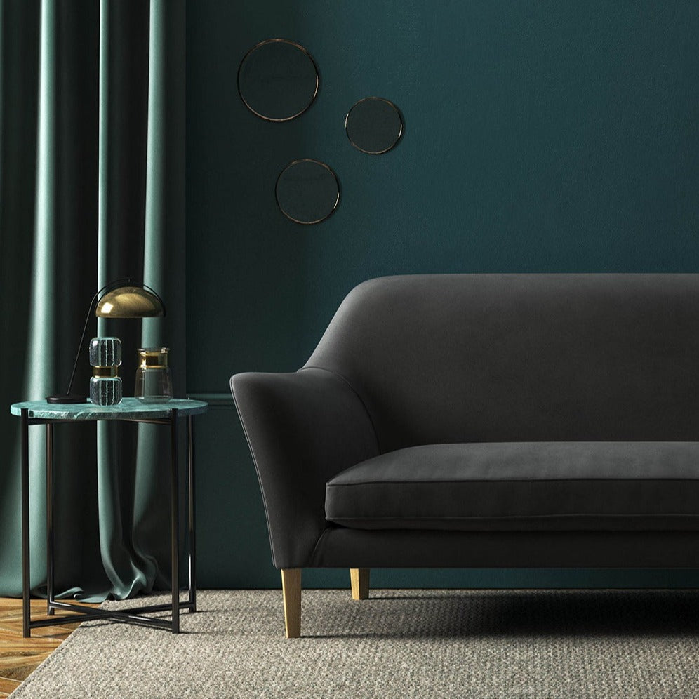 Sofa covered in a grey velvet upholstery fabric 