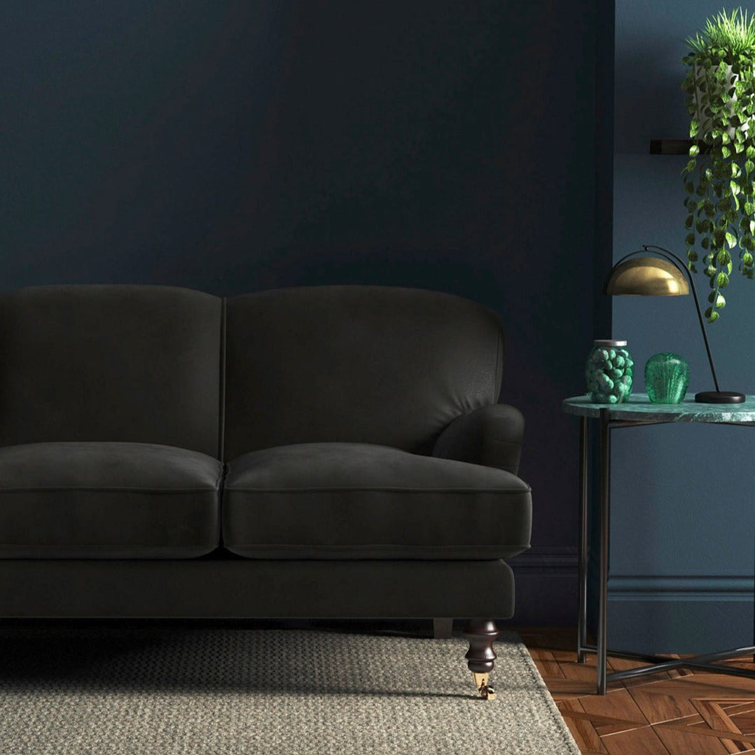 Sofa covered in a grey velvet upholstery fabric