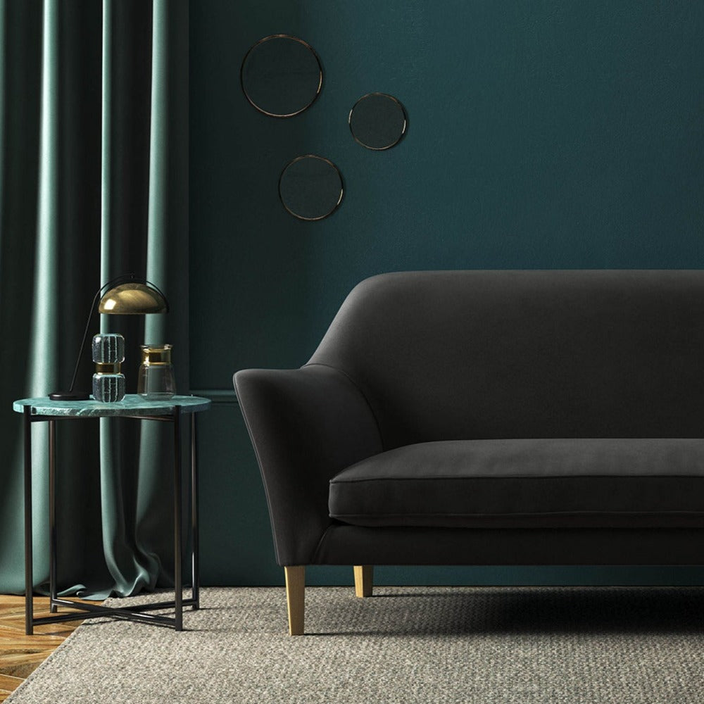 Sofa covered in a grey velvet upholstery fabric 