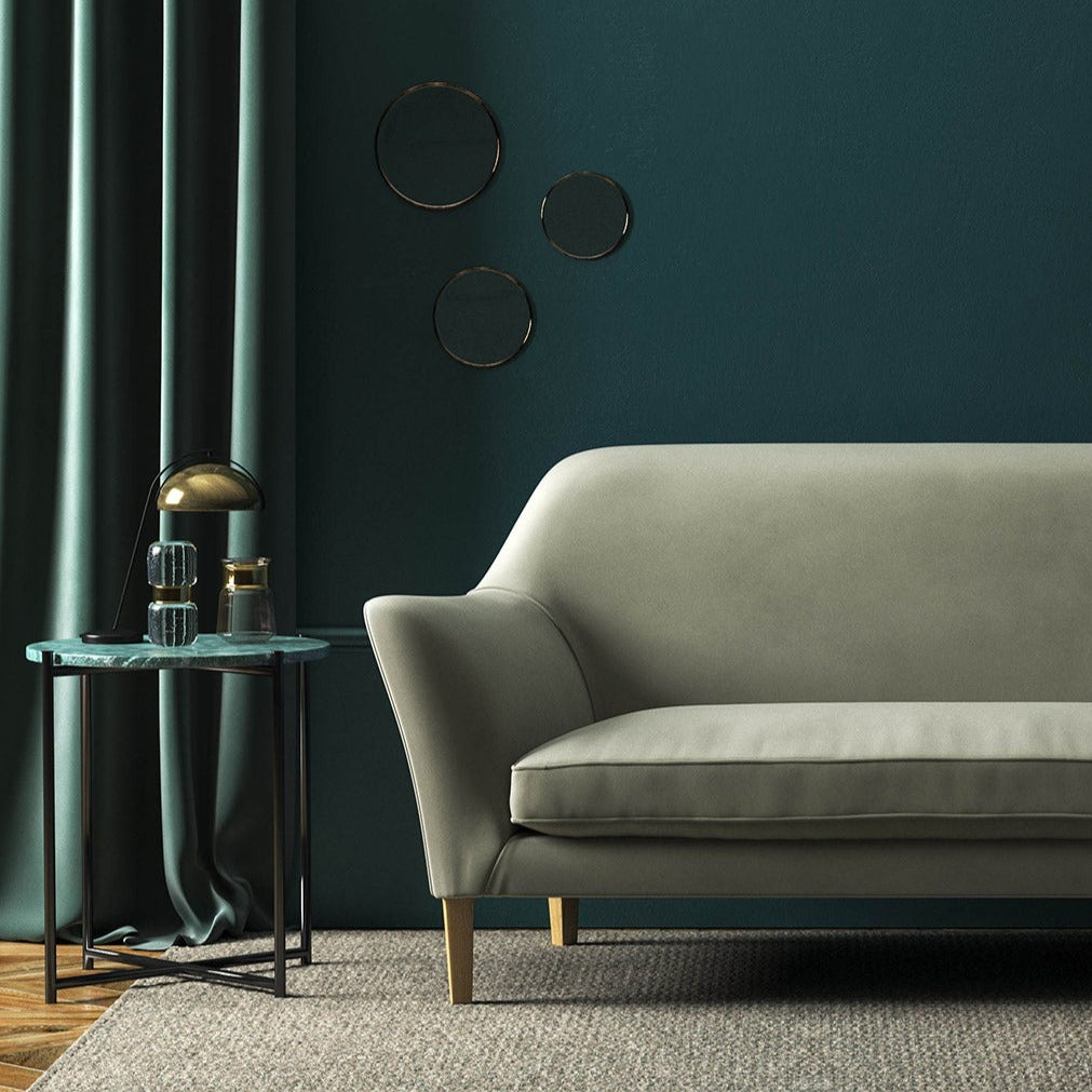 Sofa covered in a grey velvet upholstery fabric 
