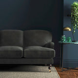 Sofa covered in a grey velvet upholstery fabric