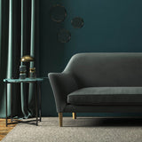 Sofa covered in a grey velvet upholstery fabric 
