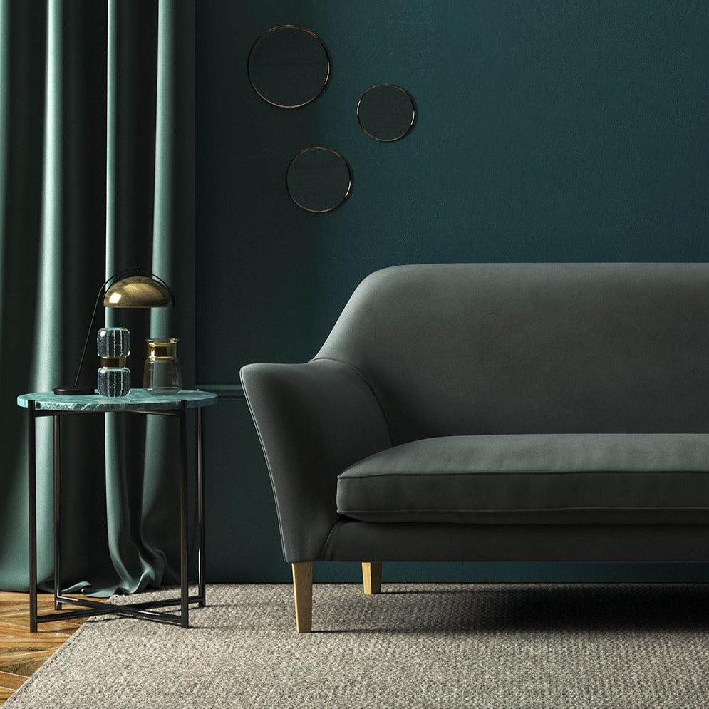 Sofa covered in a grey velvet upholstery fabric 