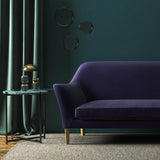 Sofa covered in a purple velvet upholstery fabric 