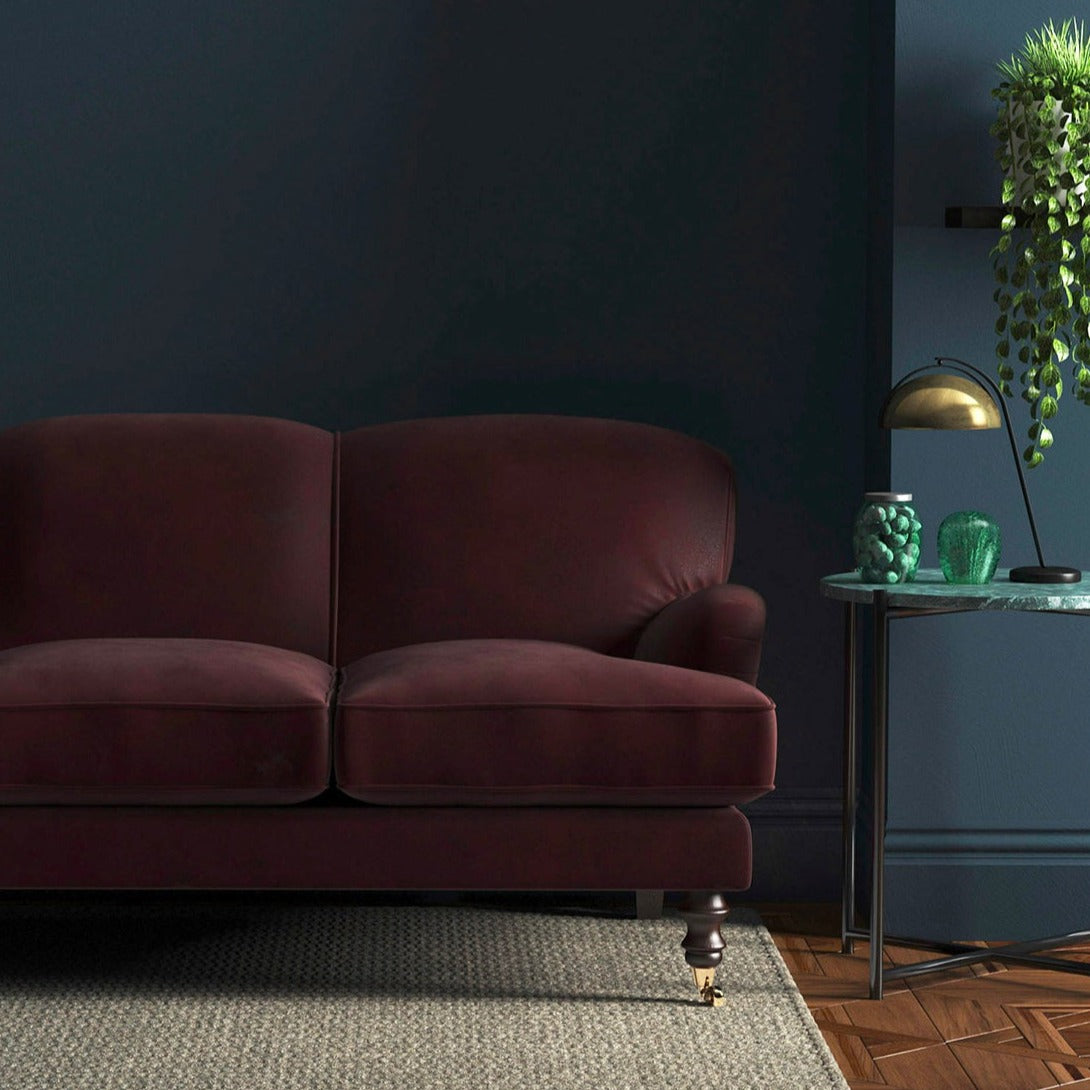 Sofa covered in a brown velvet upholstery fabric