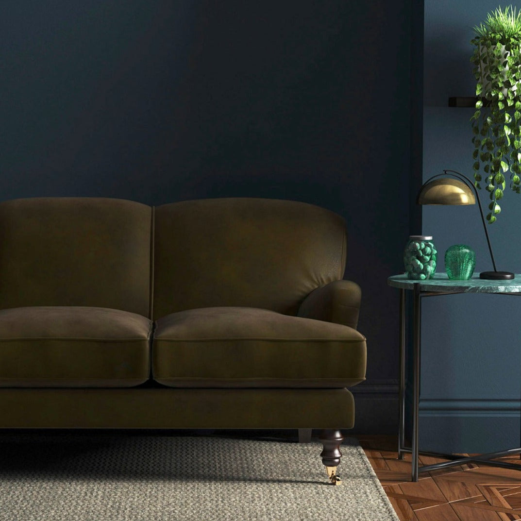 Sofa covered in a brown velvet upholstery fabric