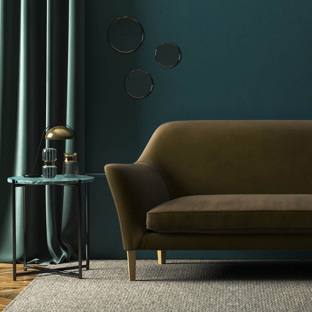Sofa covered in a brown velvet upholstery fabric 