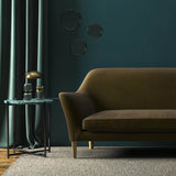 Sofa covered in a brown velvet upholstery fabric 