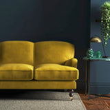 Sofa covered in a yellow velvet upholstery fabric