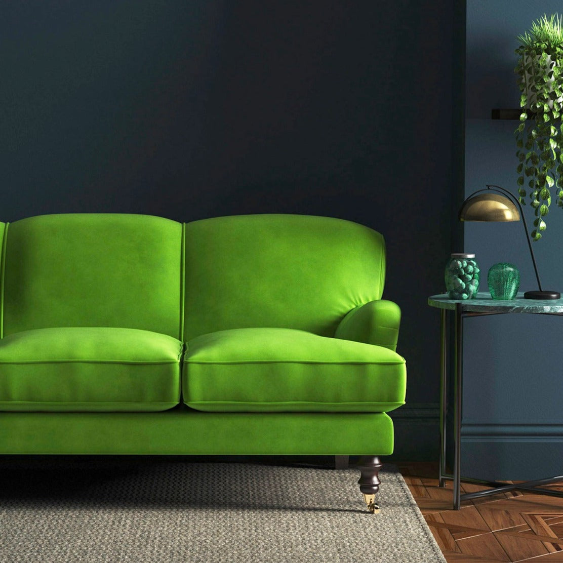 Sofa covered in a green velvet upholstery fabric