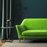 Sofa covered in a green velvet upholstery fabric 