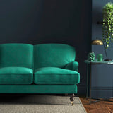 Sofa covered in a green velvet upholstery fabric