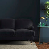 Sofa covered in a navy velvet upholstery fabric