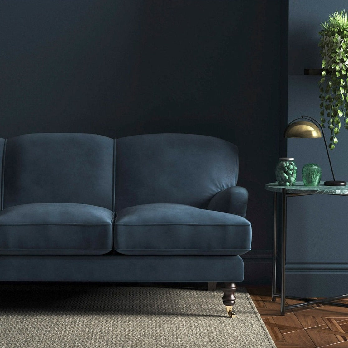 Sofa covered in a blue velvet upholstery fabric