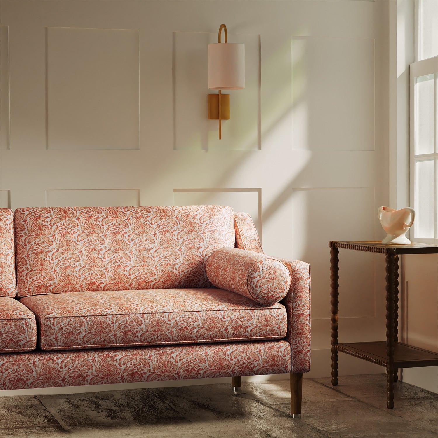 Sofa upholstered in a luxury light red floral and leaf fabric