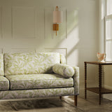 Sofa upholstered in a luxury light green floral and leaf fabric