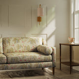 Sofa upholstered in a luxury neutral and green wisteria floral bouquet fabric