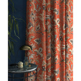 Curtains with a orange fabric with a stylised floral design