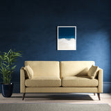 Sofa upholstered in a light yellow and neutral herringbone upholstery fabric