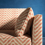 Sofa upholstered in a red and neutral herringbone upholstery fabric