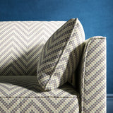 Sofa upholstered in a grey and neutral herringbone upholstery fabric