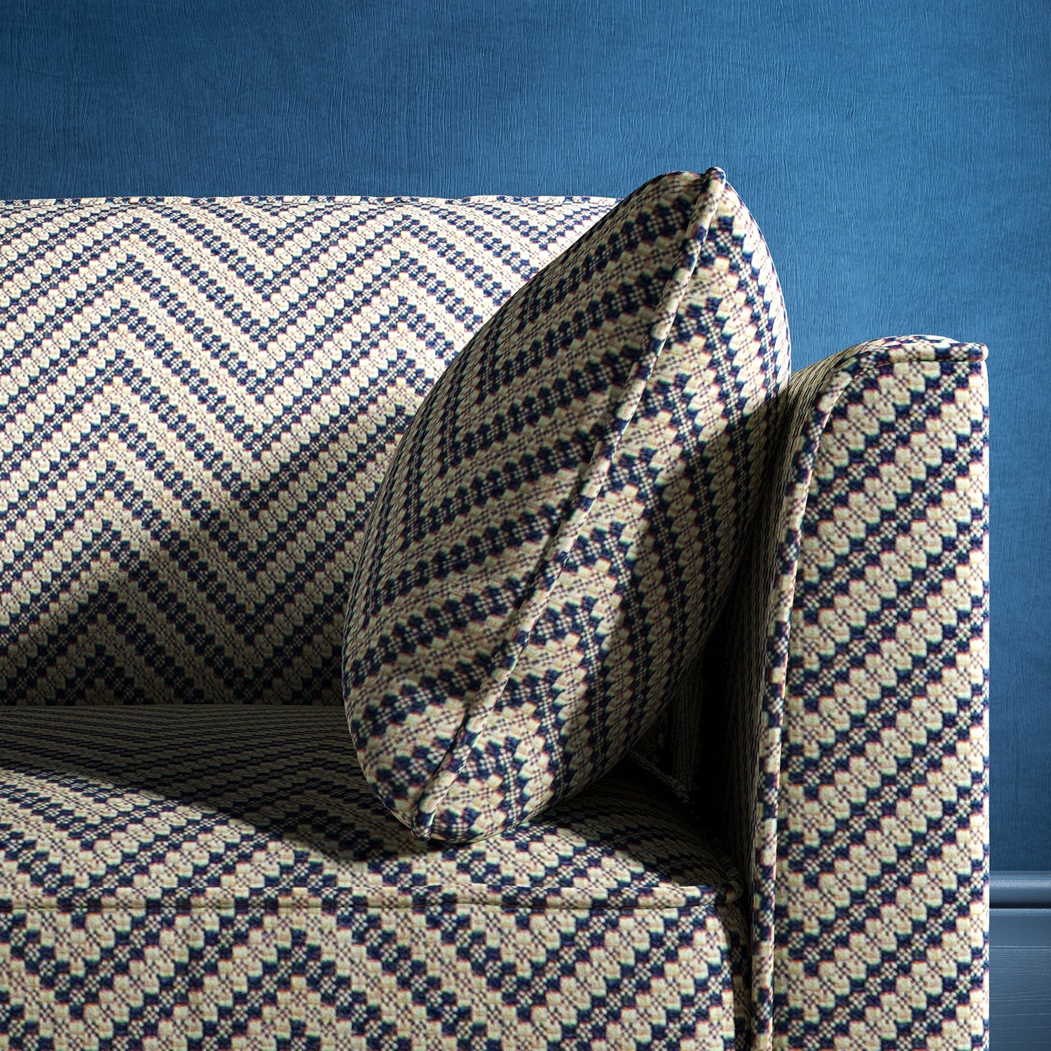 Sofa upholstered in a dark blue and neutral herringbone upholstery fabric