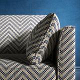 Sofa upholstered in a dark blue and neutral herringbone upholstery fabric