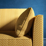 Sofa upholstered in a yellow herringbone weave upholstery fabric