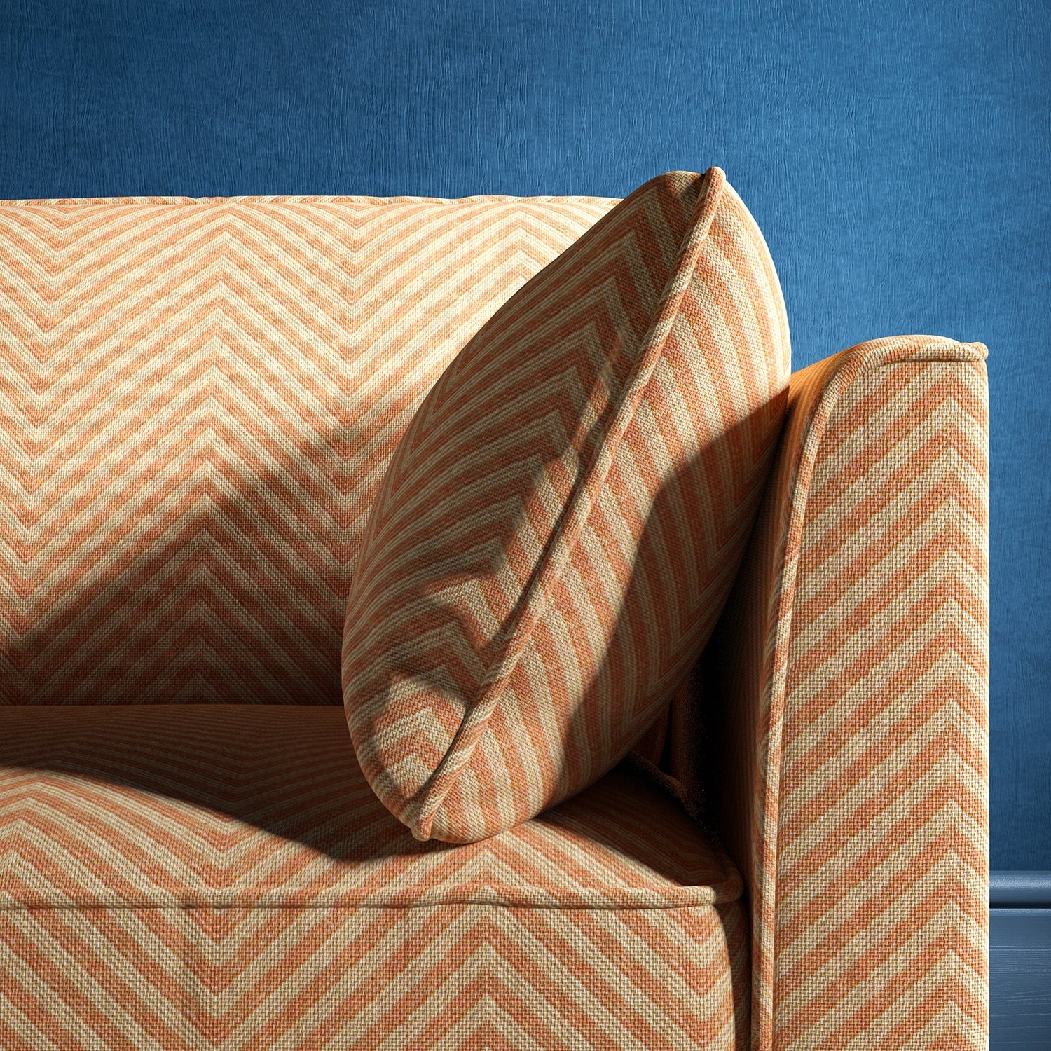 Sofa upholstered in a orange herringbone weave upholstery fabric
