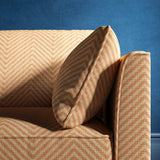 Sofa upholstered in a orange herringbone weave upholstery fabric