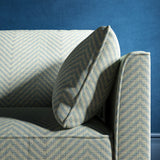 Sofa upholstered in a blue herringbone weave upholstery fabric