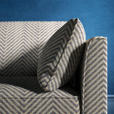 Sofa upholstered in a navy herringbone weave upholstery fabric