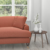 Sofa in a terracotta fabric with a light woven neutral geometric design