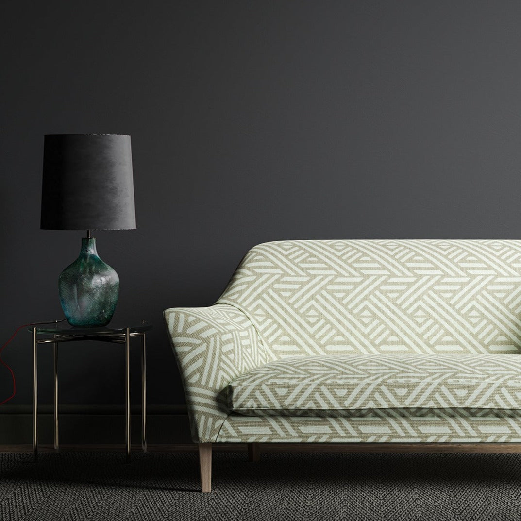 Sofa upholstered in a grey and white print fabric with a large scale geometric design