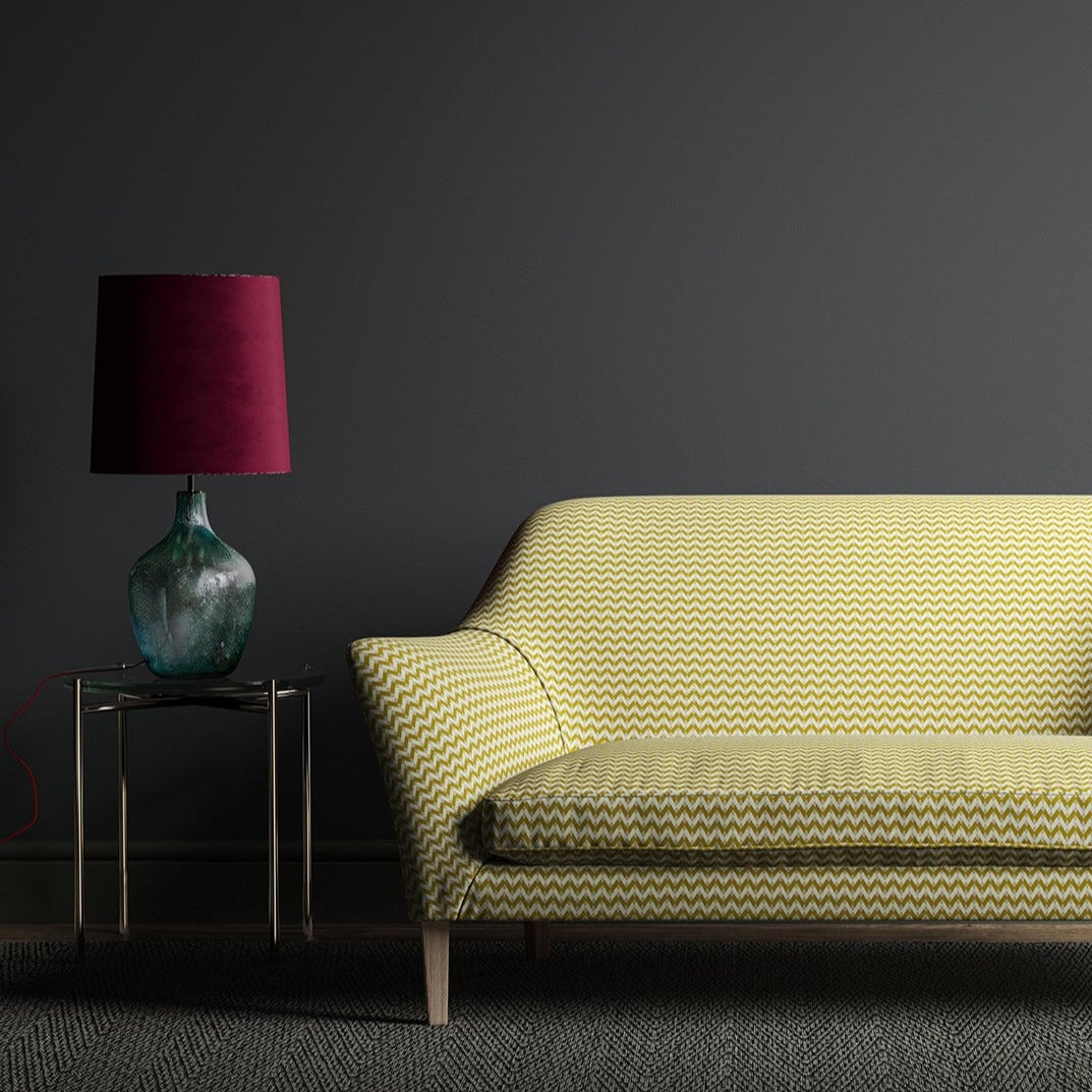 Sofa upholstered in a small scale geometric weave with yellow and neutral colours