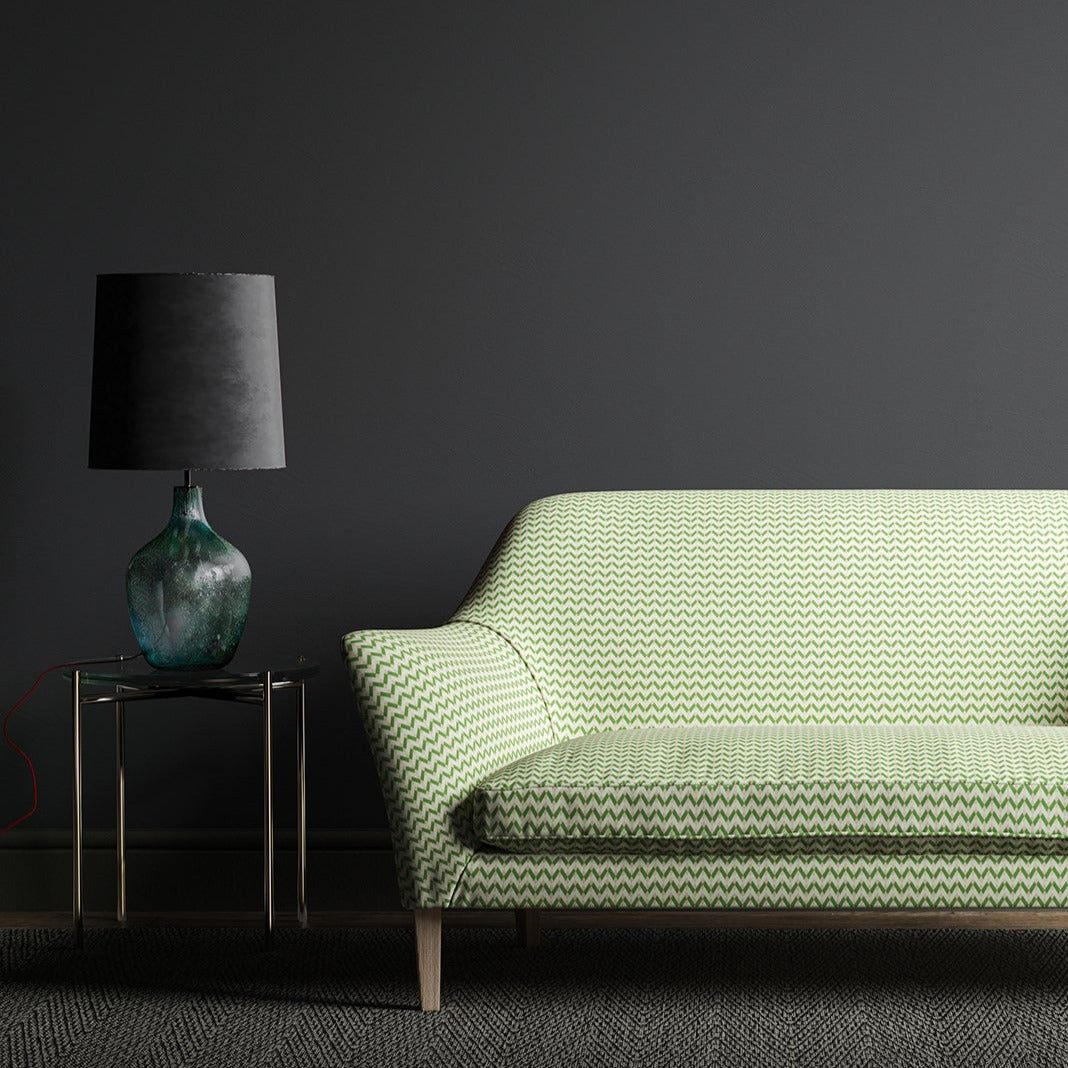 Sofa upholstered in a small scale green, pink and cream geometric weave