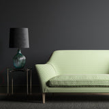 Sofa upholstered in a small scale green, pink and cream geometric weave