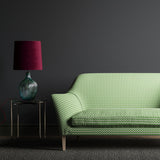 Sofa upholstered in a green, cream and dark grey geometric weave fabric