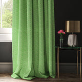 Curtain made with a green and white wavy weave fabric.