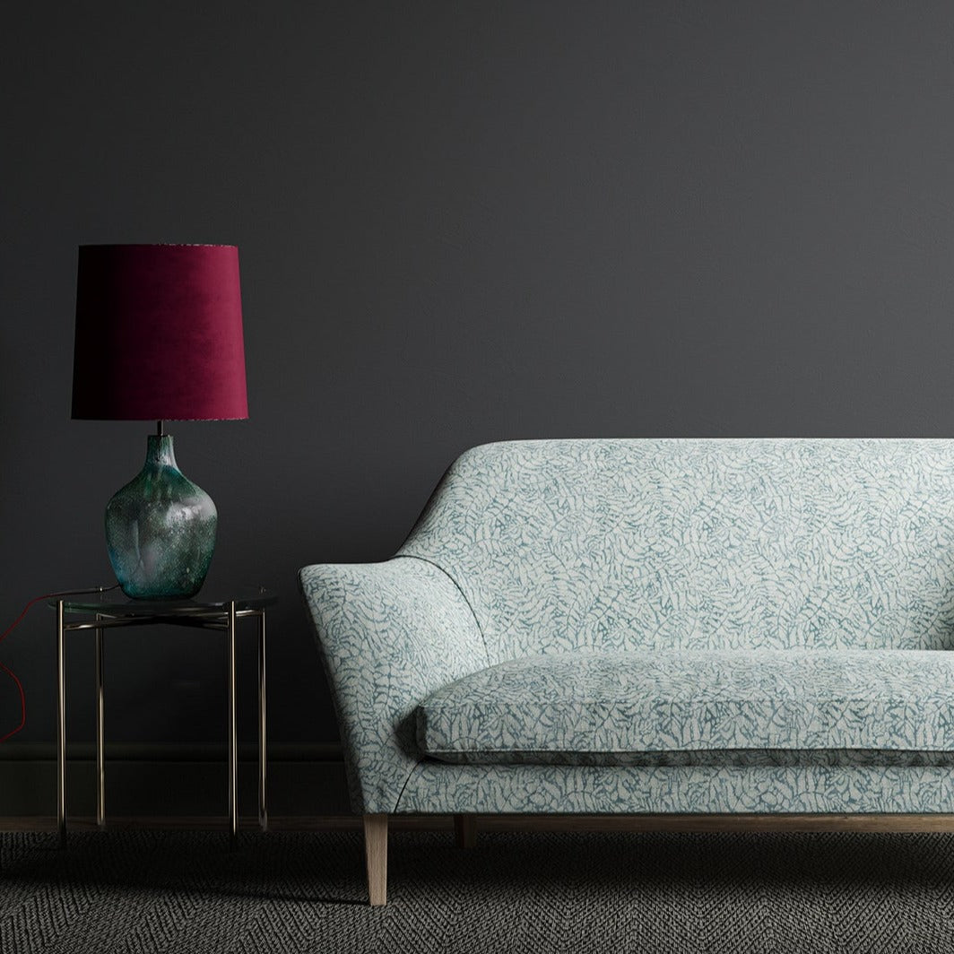 Blue sofa with a small white tropical print
