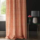 Orange woven curtain fabric with a small white print
