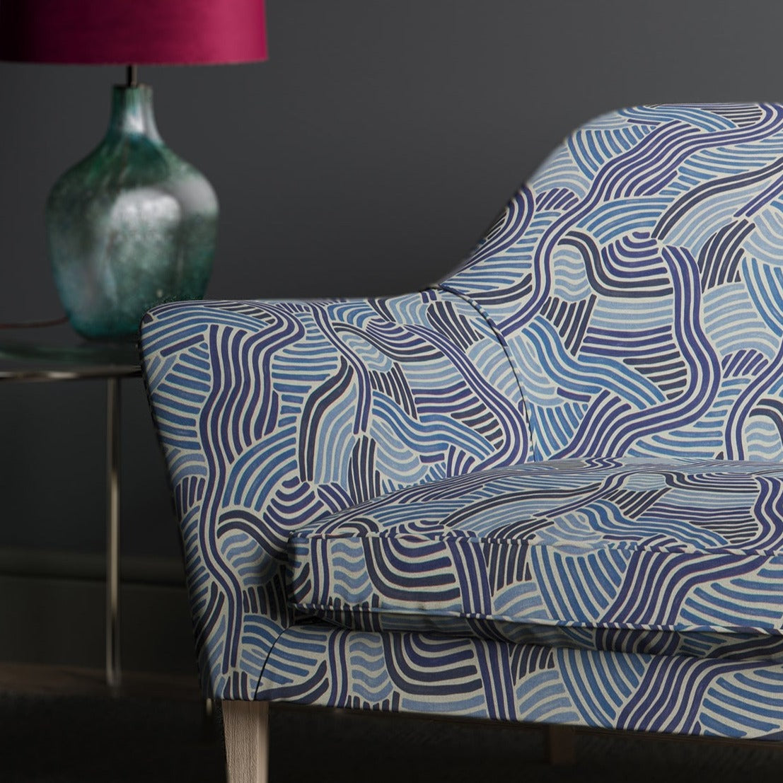 Sofa upholstered in a  blue wavy printed linen fabric