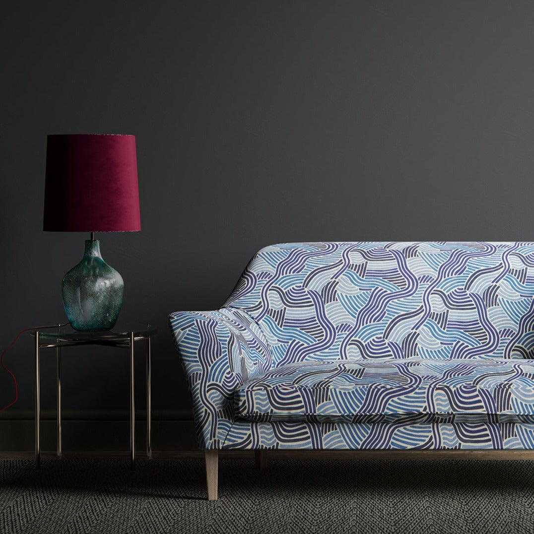 Sofa upholstered in a  blue wavy printed linen fabric