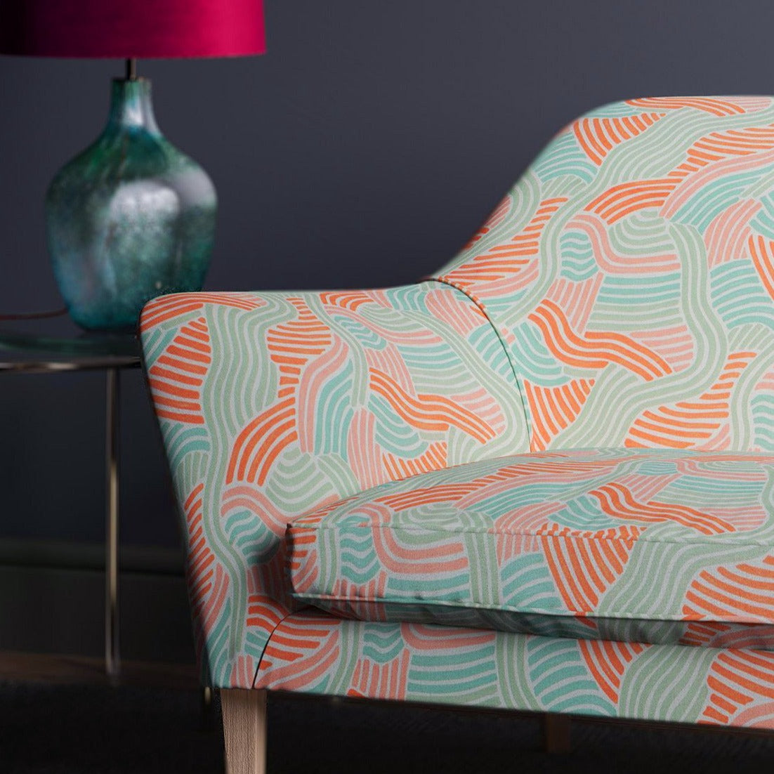 Sofa showcasing a wavy design in pastel pink and green on a linen fabric